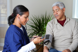 elderly man having his blood pressure checked