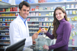 male pharmacist assisting a female customer
